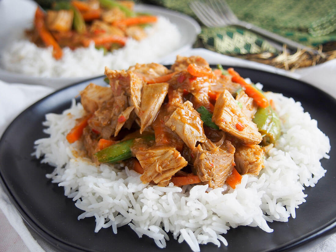 This delicious Thai red curry is made with a quick homemade paste from scratch for a fantastic bold flavor. Plus it's a great way to use leftover meat. plate of Thai red curry using leftovers, served over rice