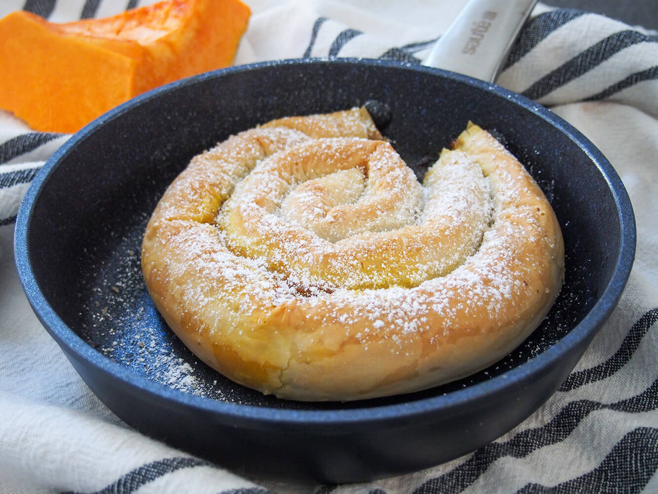 Tikvenik is a coiled pumpkin strudel from Bulgaria, with crisp filo pastry encasing a gently sweet pumpkin filling, warmed with cinnamon. It has a wonderful flavor, and this pretty pastry is easier than it looks. tikvenik (Bulgarian pumpkin strudel) in skillet