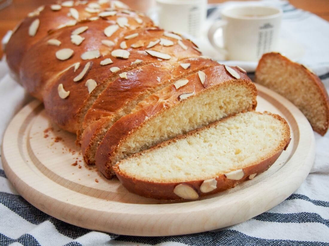 Tsoureki is the traditional Greek Easter bread that's a deliciously soft, gently sweet yeast bread similar to brioche or challah but with it's own distinctive flavor. It's wonderful enjoyed on it's own when fresh and leftovers make fantastic French toast. Tsoureki - Greek Easter bread with slices cut and one slice flat on board