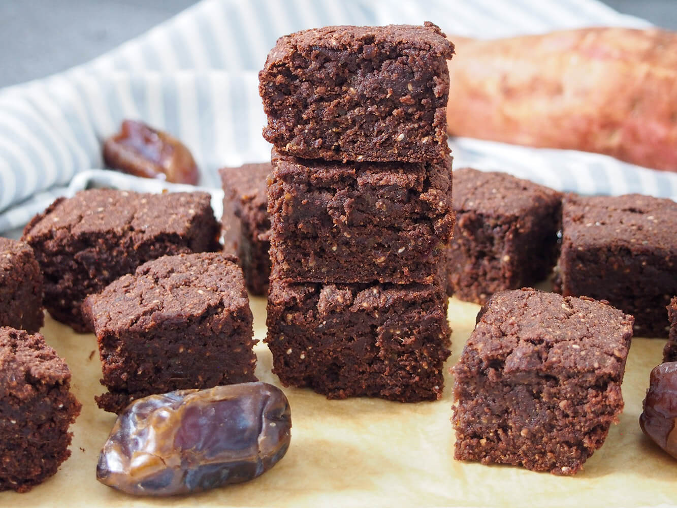 These vegan sweet potato brownies and soft, fudgy and with a delicious chocolate flavor. Plus with no refined sugar, and being gluten free, you have every excuse to enjoy more! vegan sweet potato brownies with some in stack and others to side
