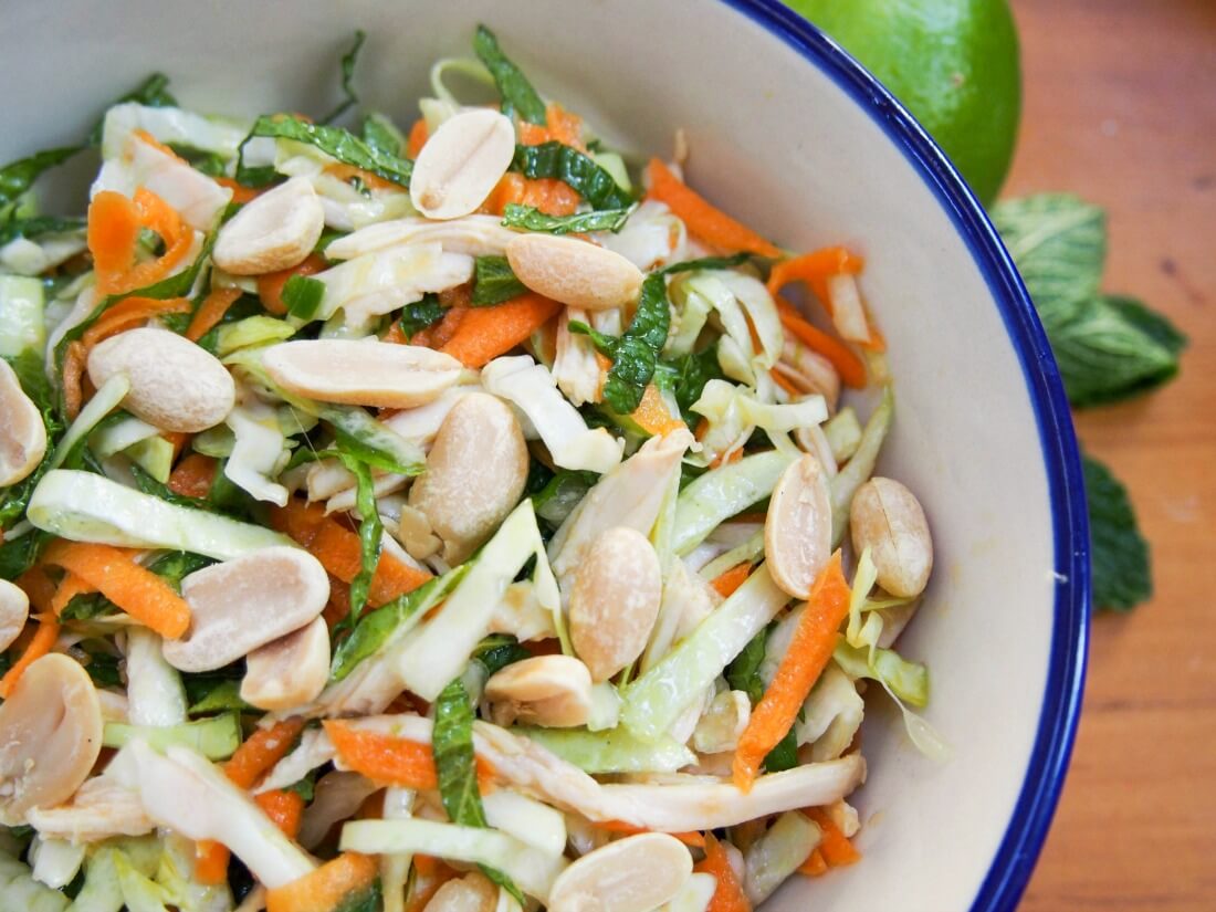 Vietnamese chicken salad is simple but delicious - a great way to enjoy leftover chicken (or turkey) alongside vegetables, mint and a punchy Asian dressing. It's perfect for your lunchbox or to take on a picnic too. Vietnamese chicken salad close up of part of bowl
