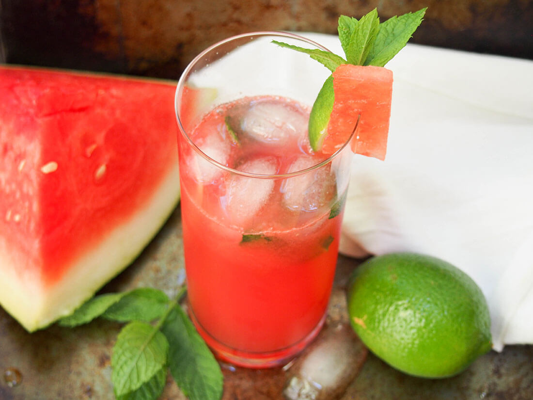 glass of watermelon mojito, a wonderfully refreshing cocktail for summer glass of watermelon mojito with watermelon slice to side
