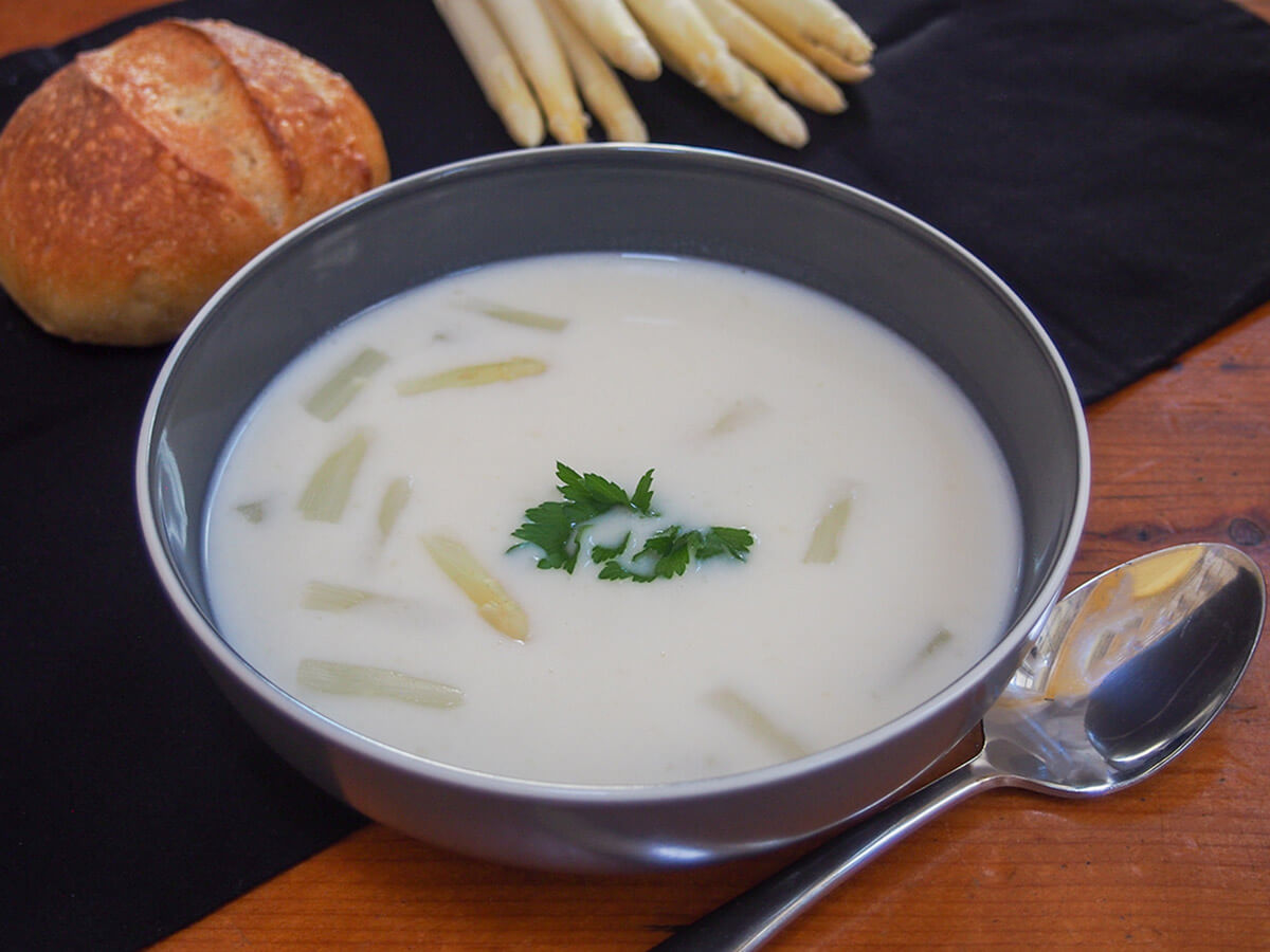 bowl of white asparagus soup bowl of white asparagus soup with spoon to side