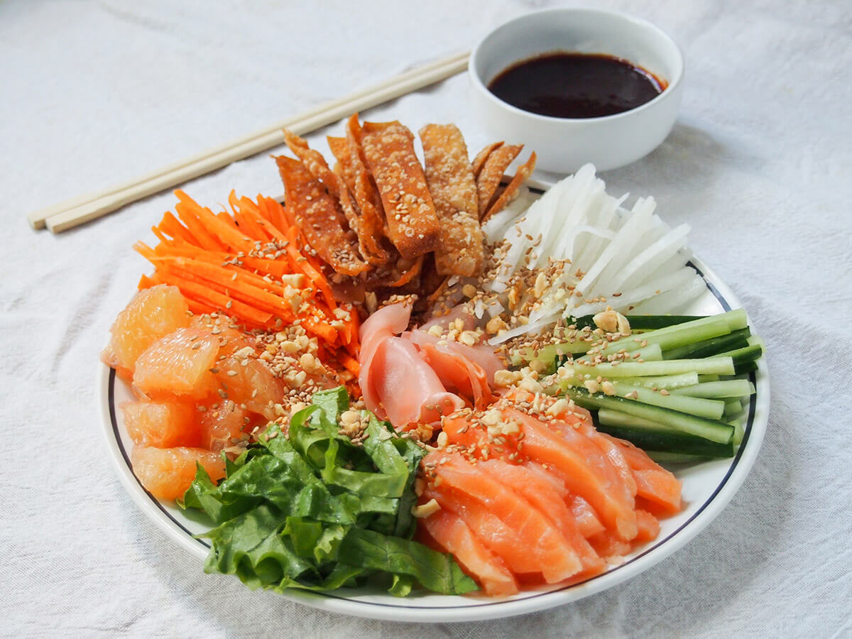 Yee sang is commonly eaten during Chinese New Year in a number of communities. It starts off as separate components that are tossed together for luck and prosperity - hence the name prosperity toss salad. It's a tasty combination. plate of yee sang prosperity toss with chopsticks behind.